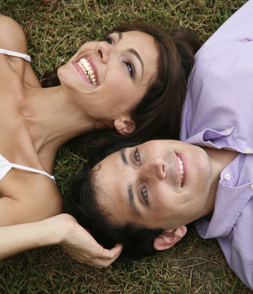 Smiling couple laying on grass